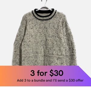 His or hers hand knitted textured crew neck sweater.